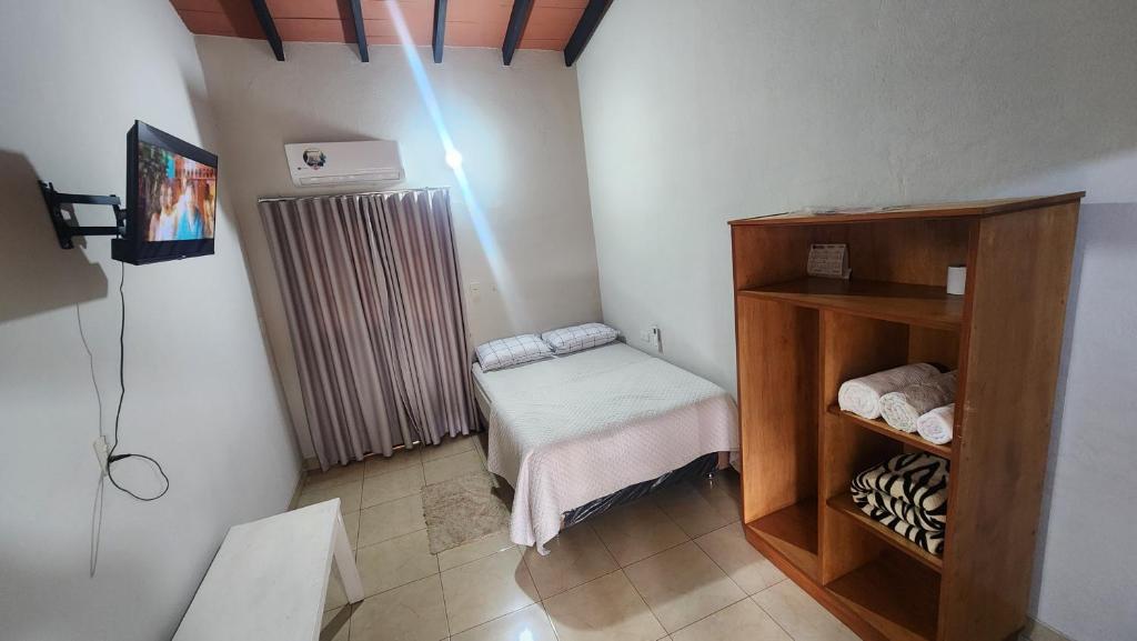 a room with a small room with a radiator and a small table at Ña Maxima Casa Rural in Caacupé