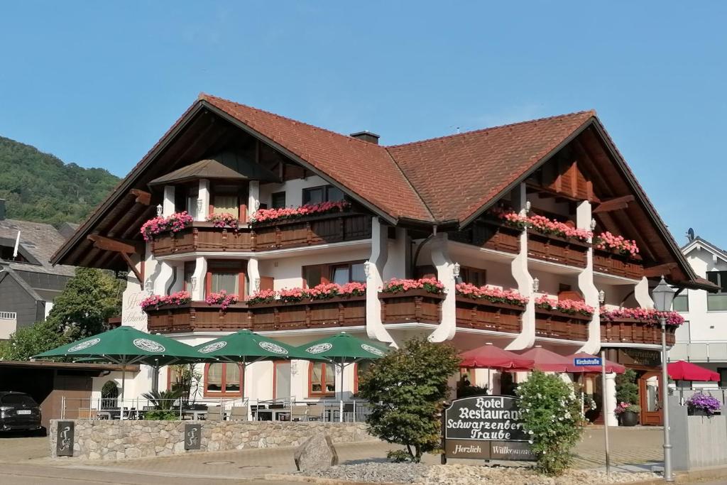 a large building with flowers on the side of it at Hotel Schwarzenbergs Traube in Glottertal
