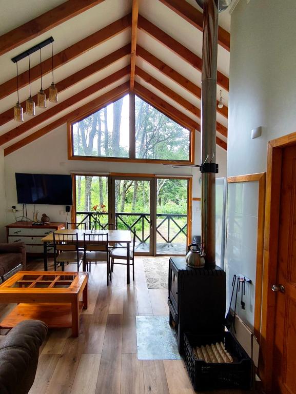 a living room with a couch and a table at Cabañas Lagos y Volcanes in Coñaripe