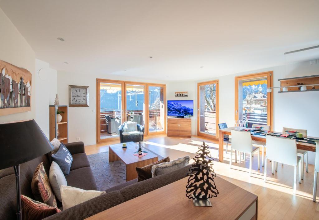 a living room with a couch and a table at Chalet Waldschluecht in Wengen