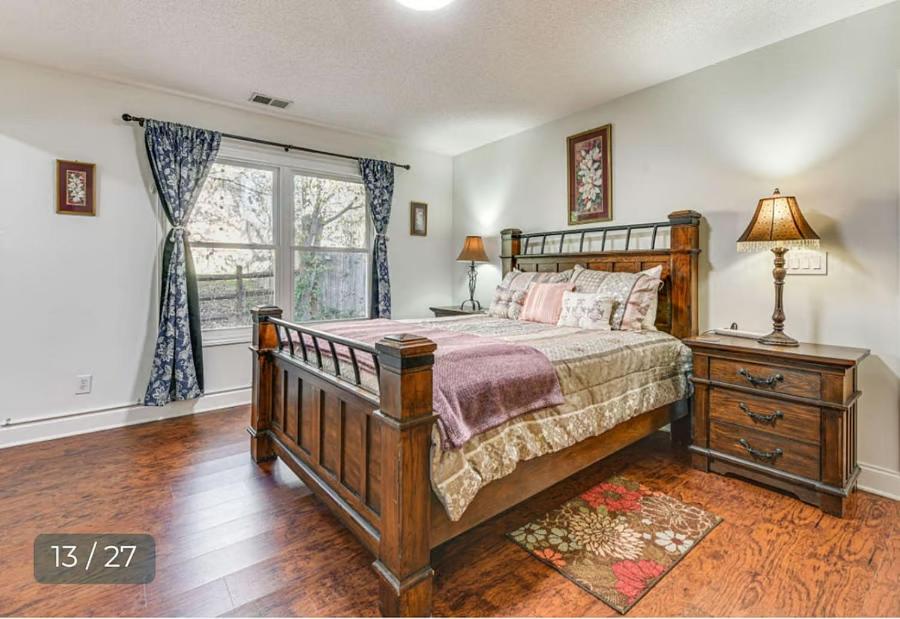 ein Schlafzimmer mit einem großen Bett und einem Fenster in der Unterkunft Grill Patio • Pet Friendly / 3 BR in Charlotte