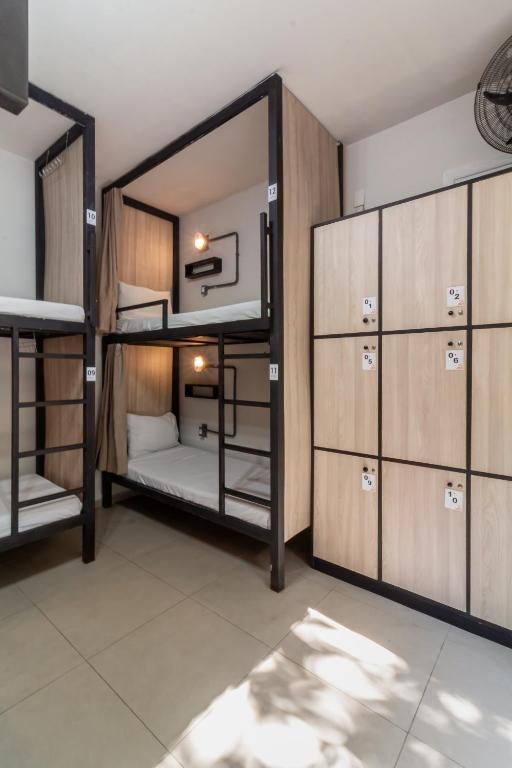 a room with two bunk beds and cabinets at Hostel Leblon in Rio de Janeiro