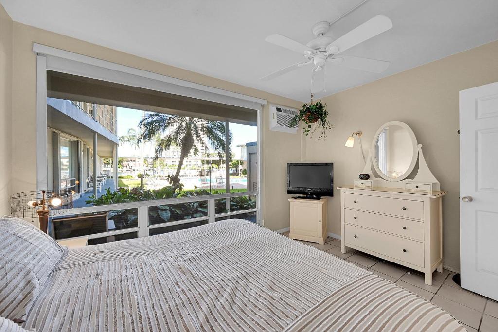 a bedroom with a bed and a window with a television at Holiday Isle Yacht Club in Fort Lauderdale