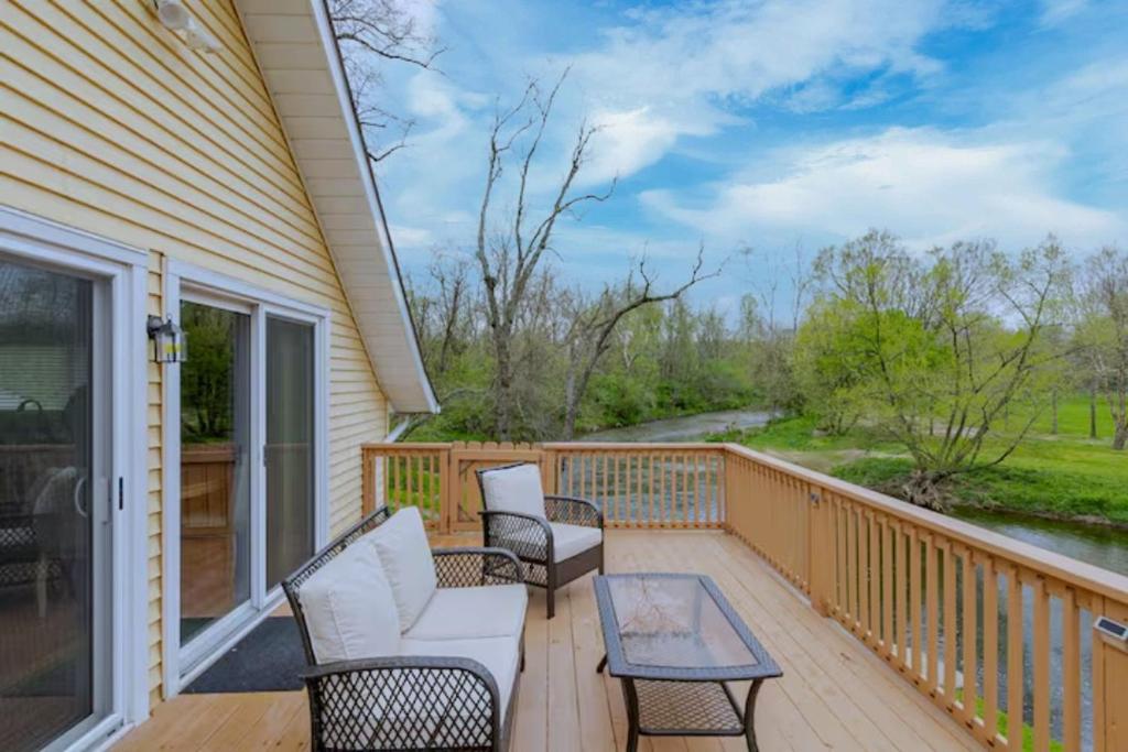 a deck with chairs and a table on a house at Boat House in Downingtown