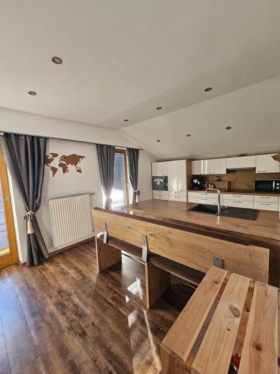 a kitchen with a wooden counter and a wooden table at Central Apartment in Radstadt
