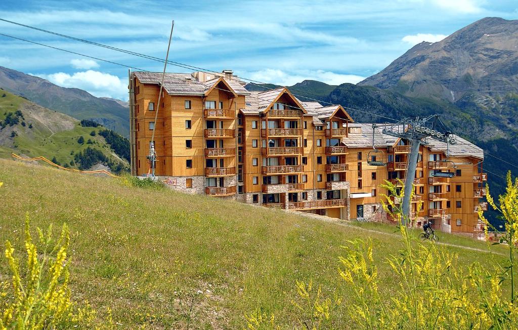 a large building on the side of a hill at Résidence Odalys Rochebrune Le Vallon in Orcières