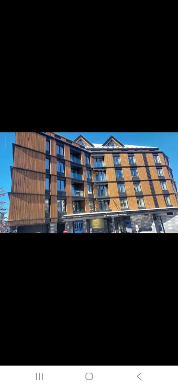 a tall building with lots of windows on it at WOODSIDE SPA AND PARKING 323 Kopaonik011 in Kopaonik
