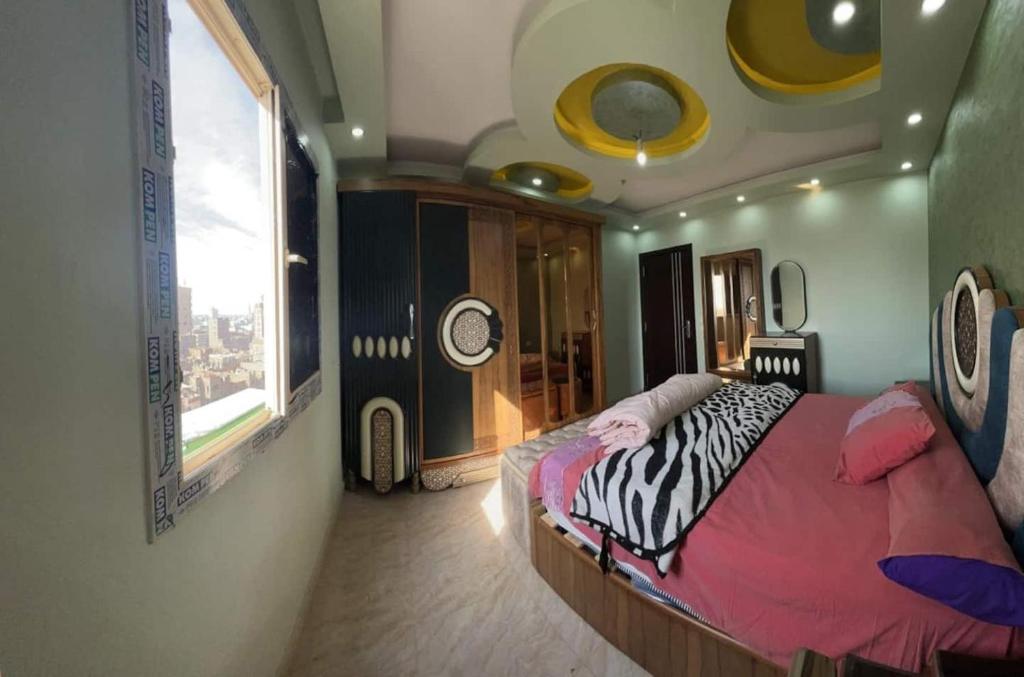 a bedroom with a bed in a room with a window at Egypt Love in Al Badrashayn