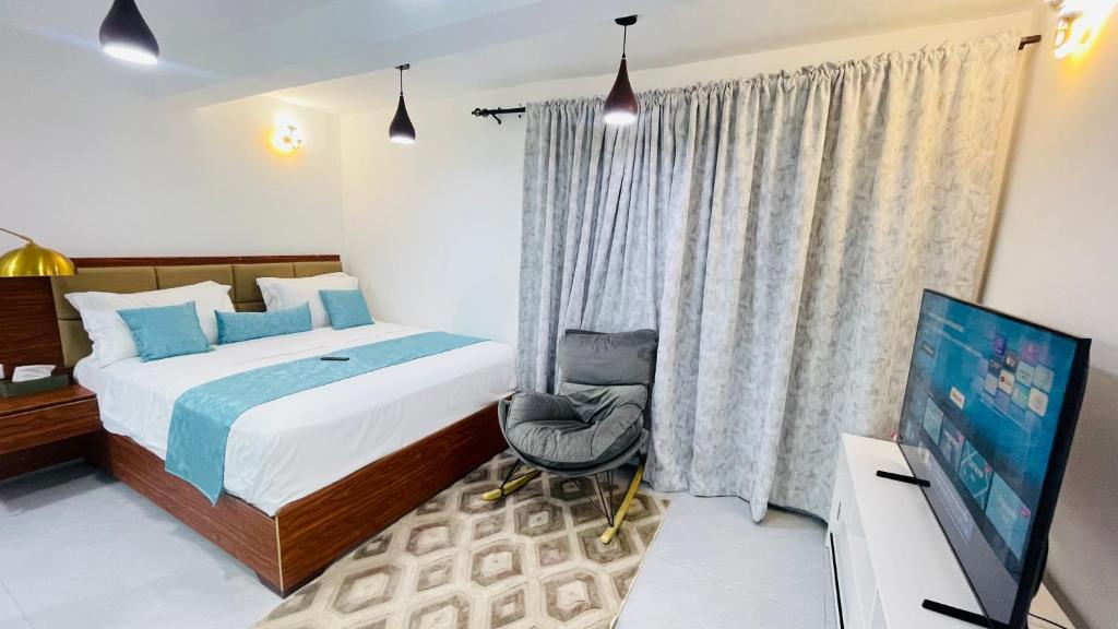 En eller flere senge i et værelse på JANO HOUSE AppartHôtel