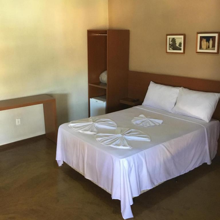 a bedroom with a bed with a bow on it at Pousada Matuto Cipó in Serra do Cipo