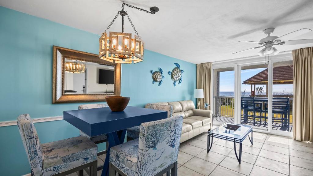 a living room with a blue wall at Romar Tower 1B in Orange Beach