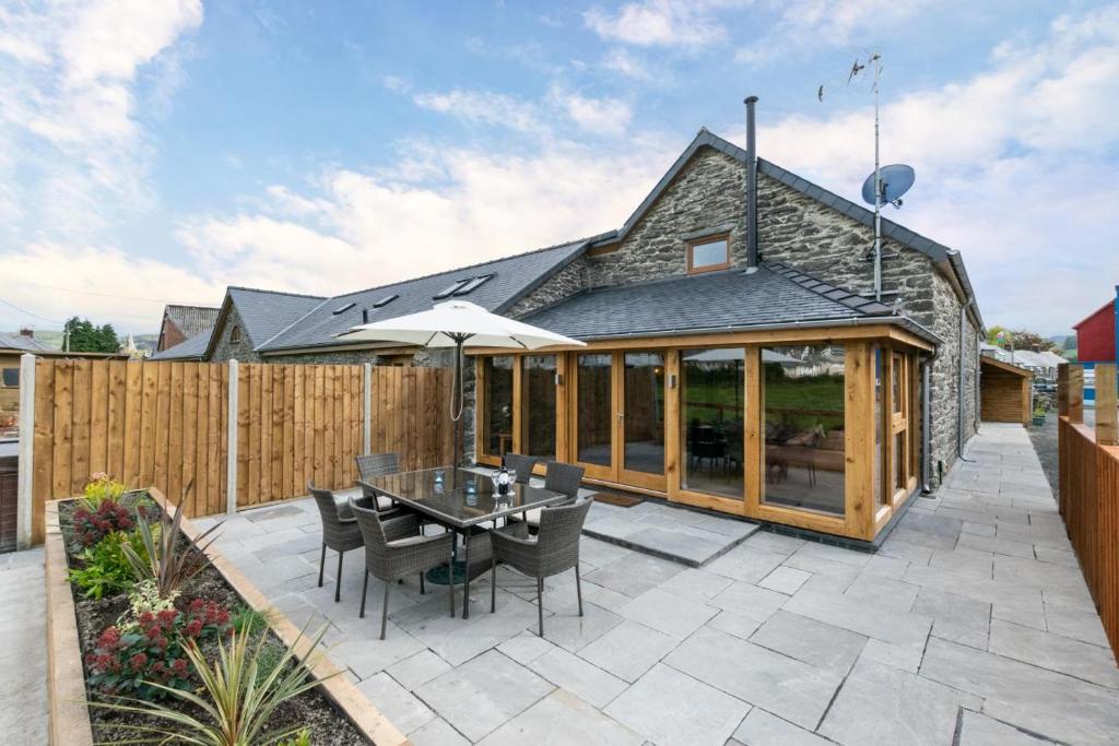a patio with a table and chairs and a fence at 3 Bed in Bala oc-bow69 in Bala