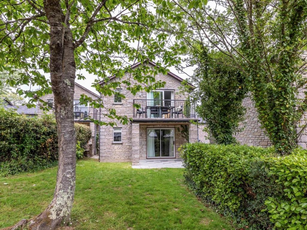 an exterior view of a brick house with a balcony at 2 Bed in Saltash oc-87703 in St. Mellion
