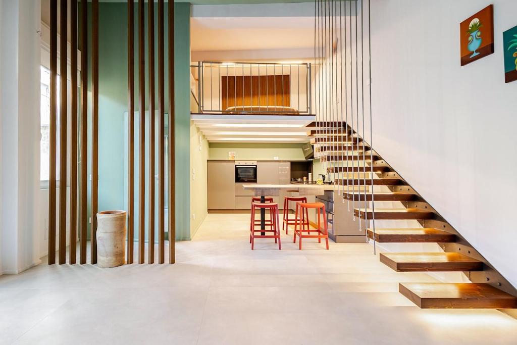 a staircase leading up to a kitchen and a living room at Living Calabriando in Reggio di Calabria