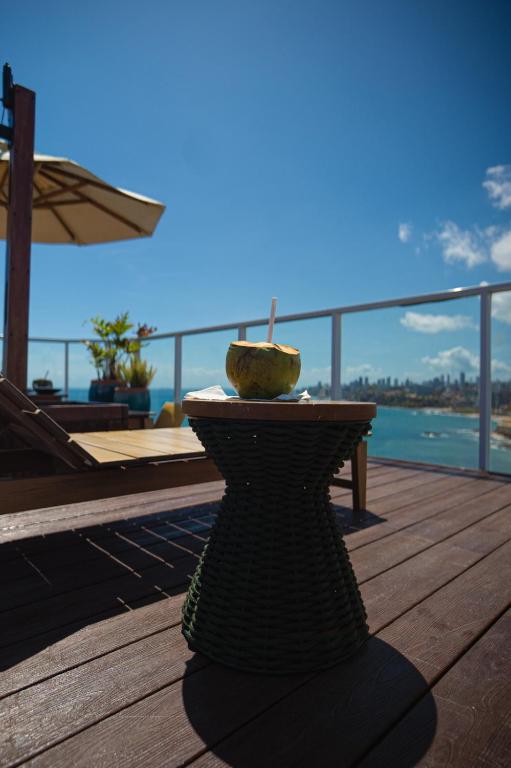 a vase sitting on a table on a deck at Hotel Camarote Salvador in Salvador