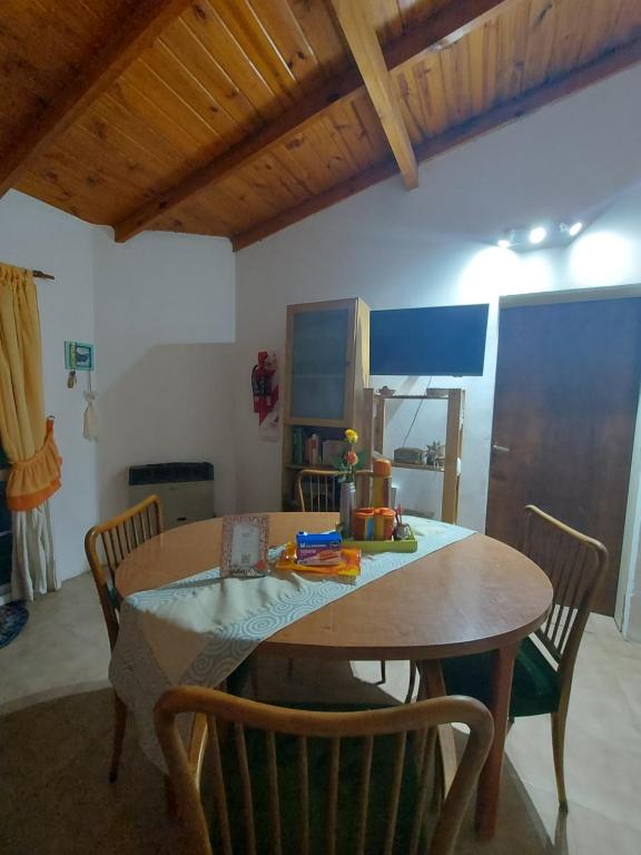 a dining room with a wooden table and chairs at Brisa Costera Studio in Carmen de Patagones