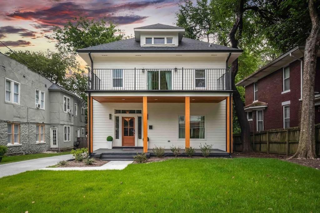 a house with a front yard with green grass at Memphis Midtown Oasis in Memphis