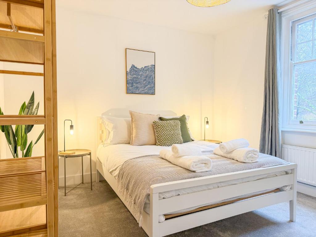 a bedroom with a bed with towels on it at Comfortable 3-Bed House near Canterbury Centre in Canterbury