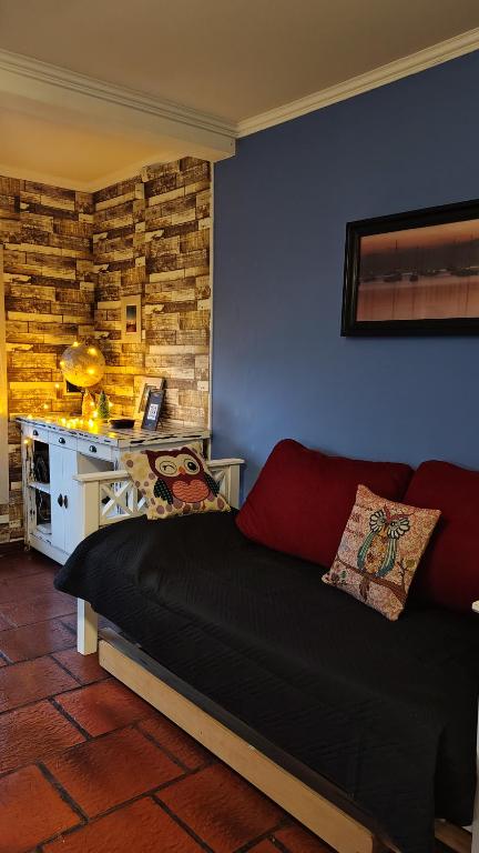 ein Wohnzimmer mit einem Sofa und einer blauen Wand in der Unterkunft Casa a 500 metros del Mar in Quequén