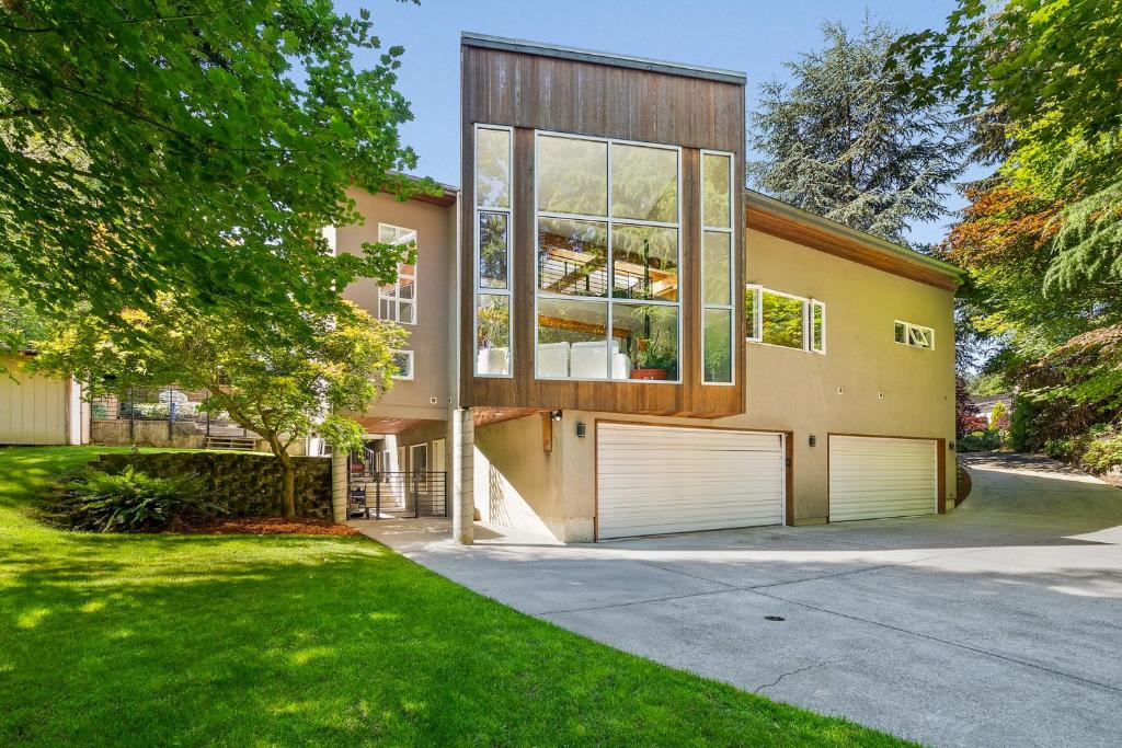 a house with two garage doors in a yard at Dash Point Modern in Tacoma