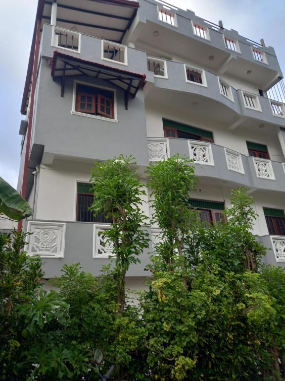 a white building with trees in front of it at Galle City Guest in Galle