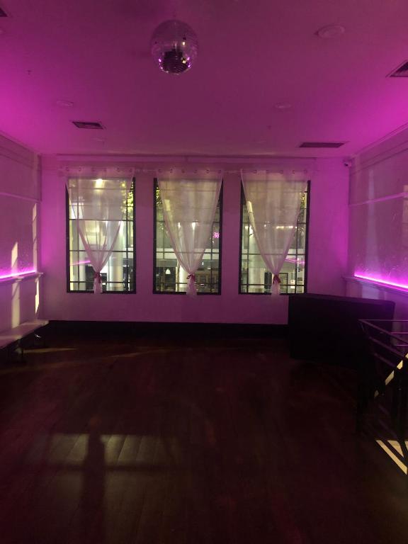 a purple room with windows with curtains at 215 Queen's FOR EVENTS ONLY NO OVERNIGHT STAY in Melbourne