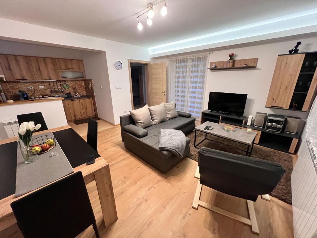 a living room with a couch and a table at Countryside rest house in Novi Banovci