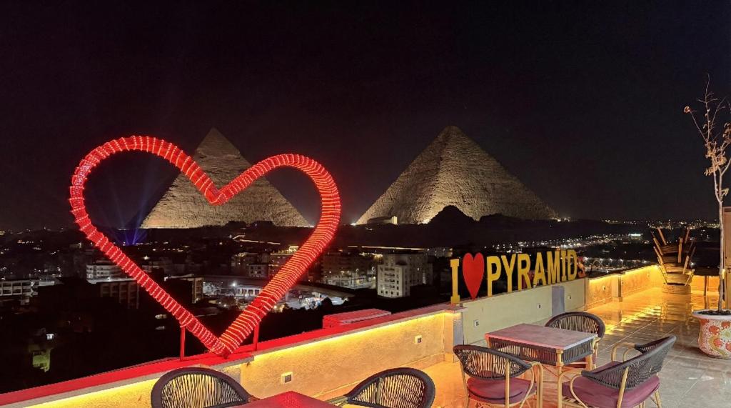 two red heart drawings on a balcony with the pyramids at GEMS Pyramids View in Cairo