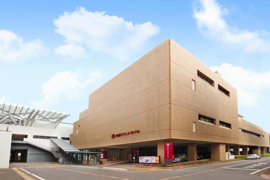 a brown building with a sign on the side of it at Nagaoka Grand Hotel in Nagaoka