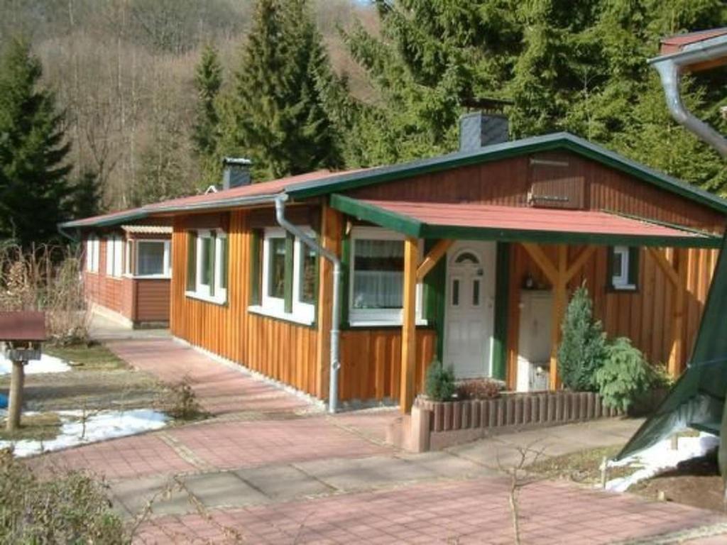 a small wooden house with a driveway in front of it at Holiday Home mit Bergblick by Interhome in Ilfeld