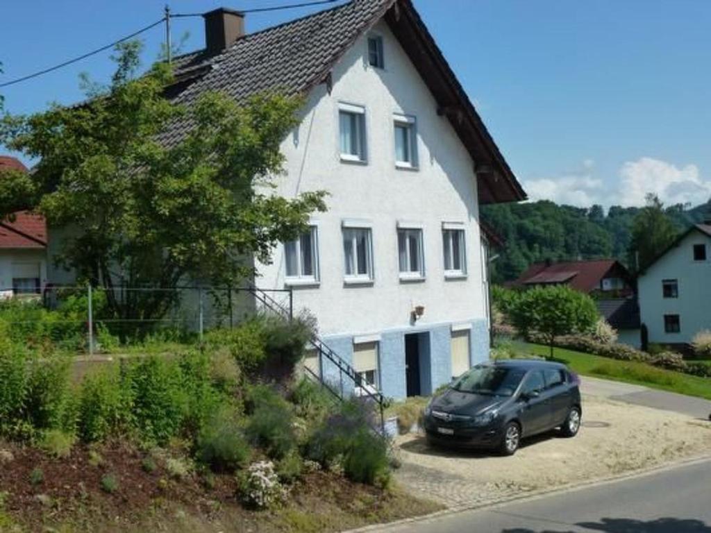 a car parked in front of a white house at Holiday Home Buschle by Interhome in Tettnang