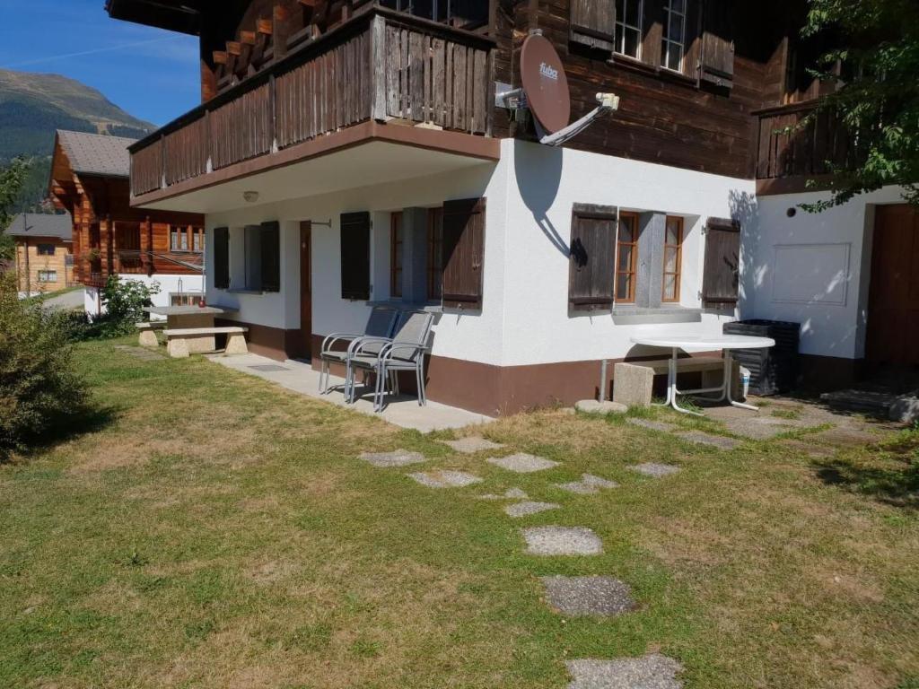 a house with a table and chairs in a yard at Apartment Ritz by Interhome in Ernen