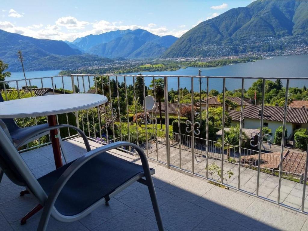 a table and chair on a balcony with a view of a lake at Apartment Casa Barbara by Interhome in Piazzogna
