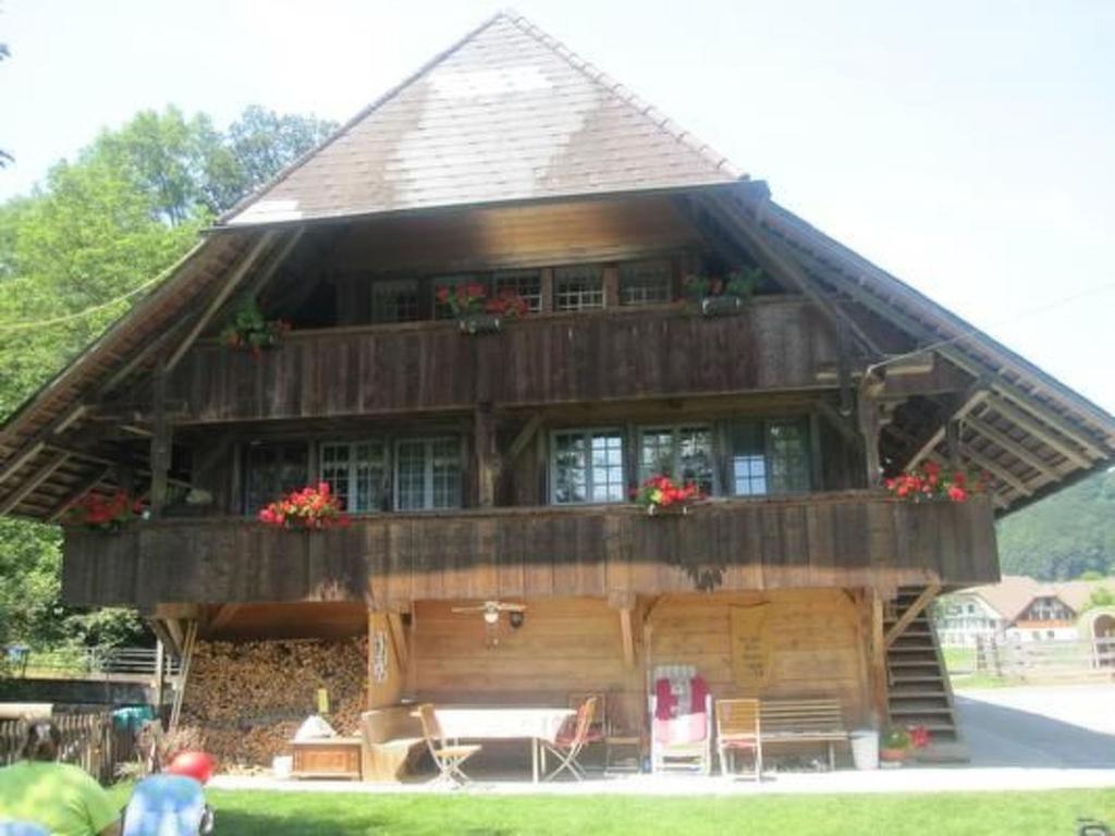 a large wooden house with a gambrel roof at Apartment Farbhaus Bleiche by Interhome in Rohrbach