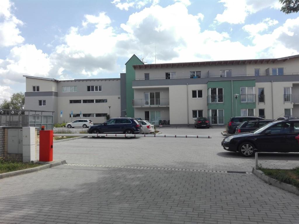 a parking lot with cars parked in front of a building at Studio 37 Třeboň in Třeboň