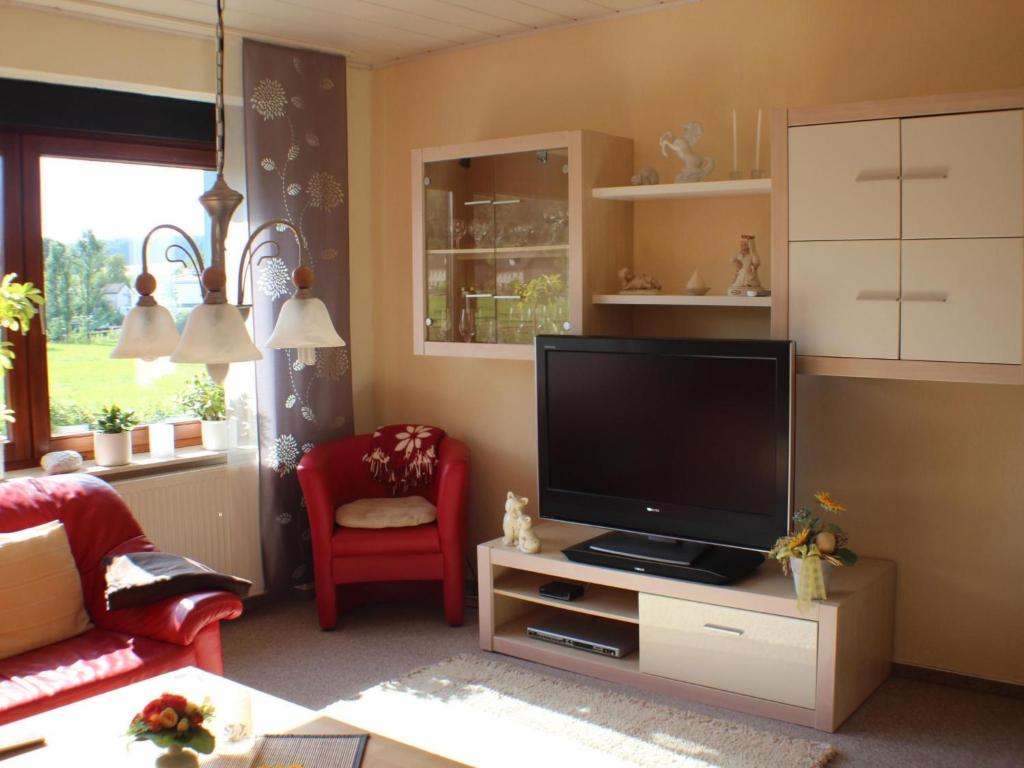 a living room with a flat screen tv on a stand at Apartment im Teutoburger Wald by Interhome in Schieder