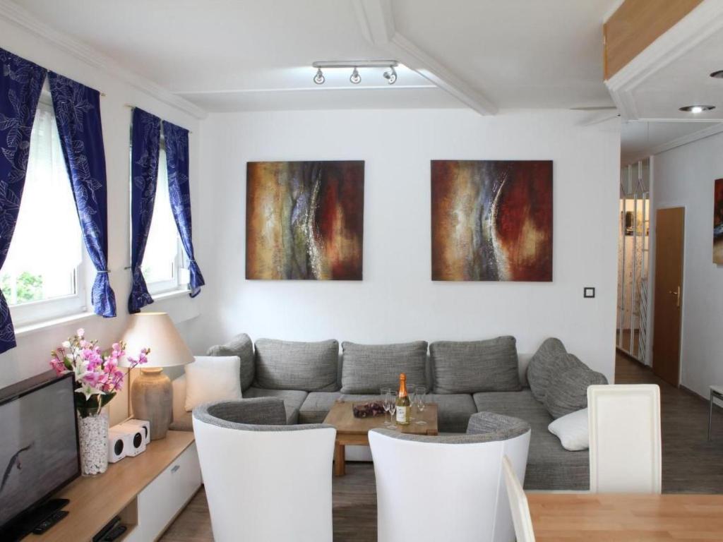 a living room with a couch and a table at Apartment Vulkaneifel by Interhome in Daun