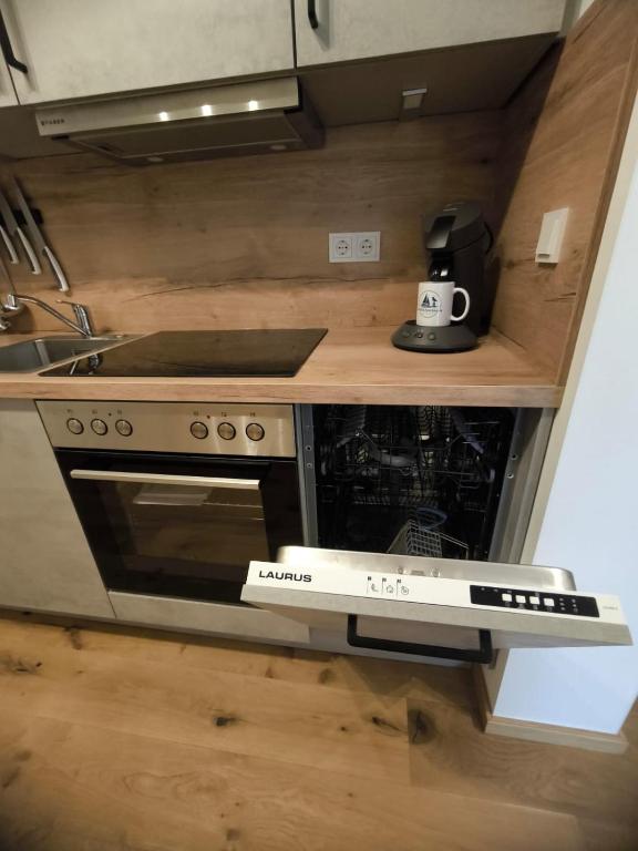 a kitchen with a stove and a counter top at SeeZeitApartments Whg 27 in Lembruch