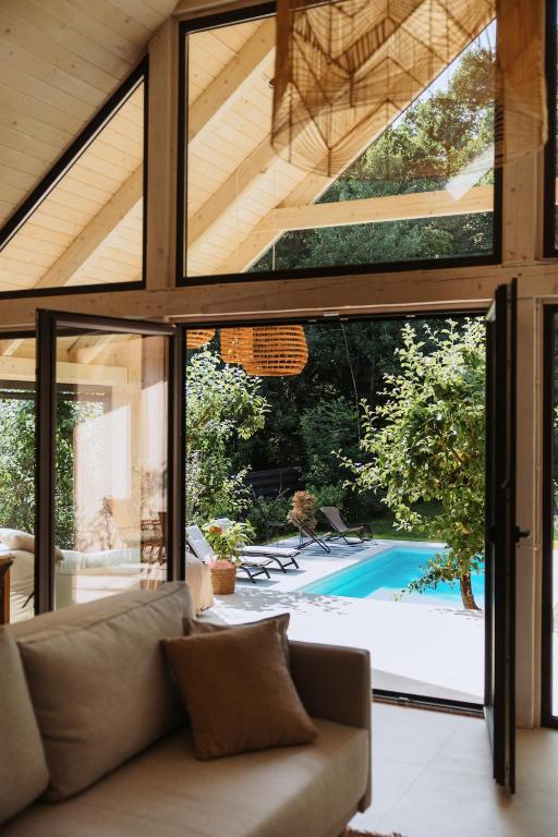 a living room with a couch and a view of a pool at Villa Lis in Ivano-Frankivsk