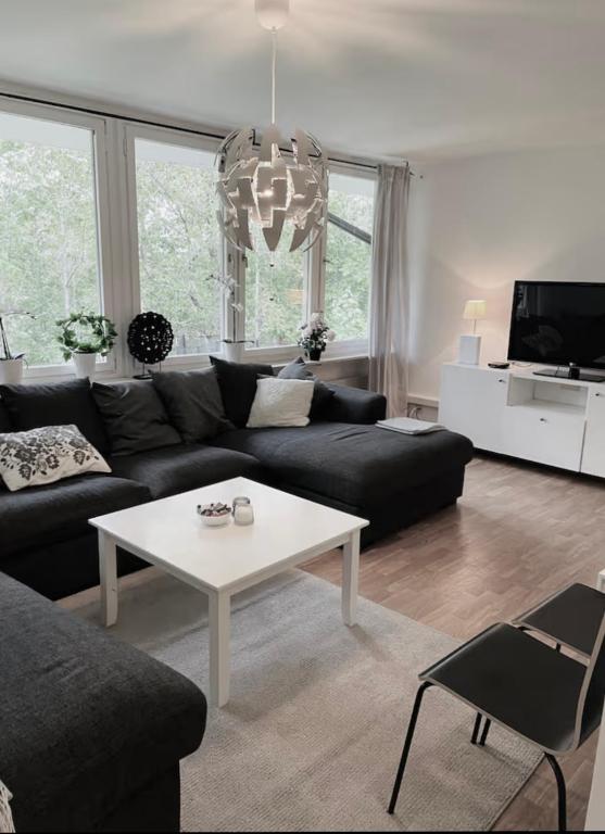 a living room with a couch and a table at Rymligt och härligt radhus i Göteborg in Gothenburg