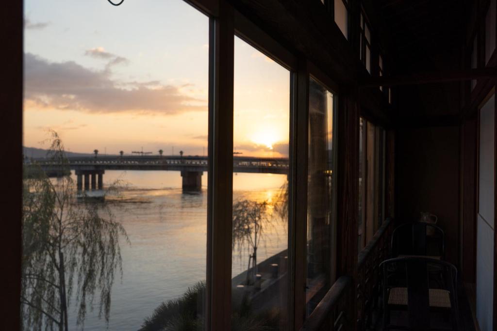 a view of a bridge from a window at 久乃家 in Matsue