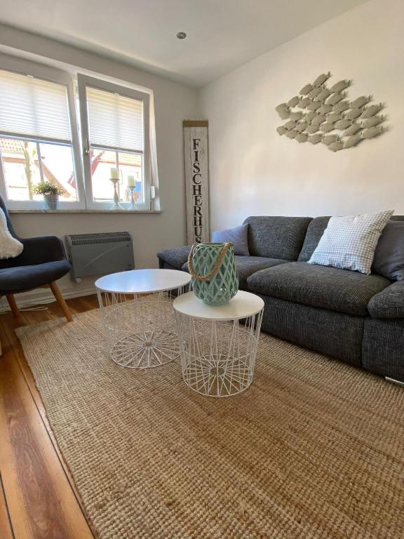 a living room with a couch and two tables at Fischerhus in Fehmarn