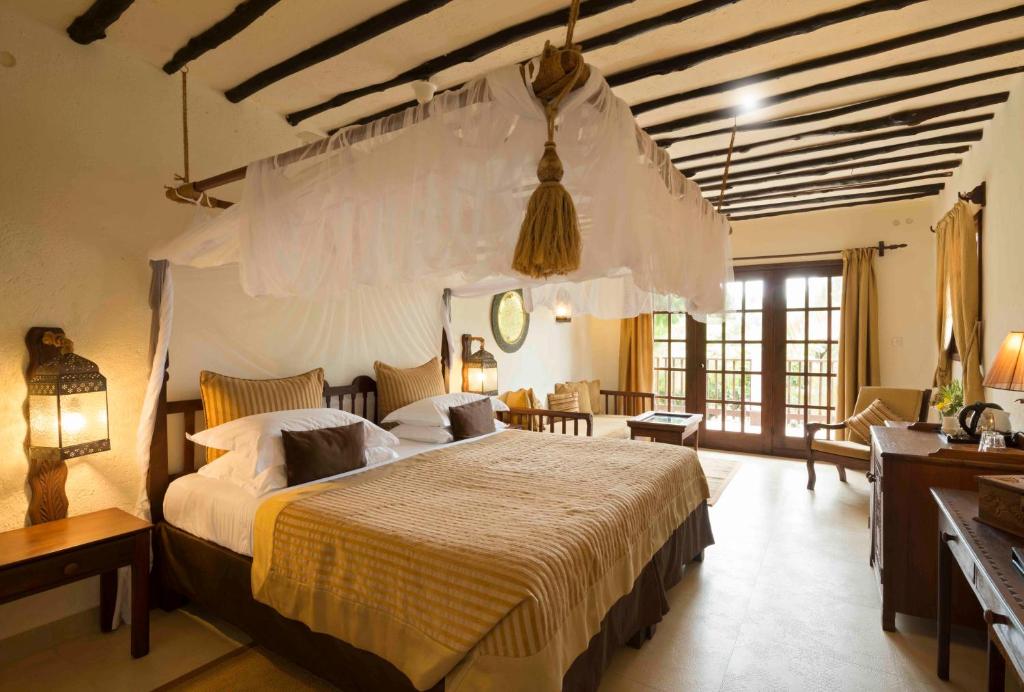 een slaapkamer met een groot bed in een kamer bij Breezes Beach Club and Spa in Bwejuu
