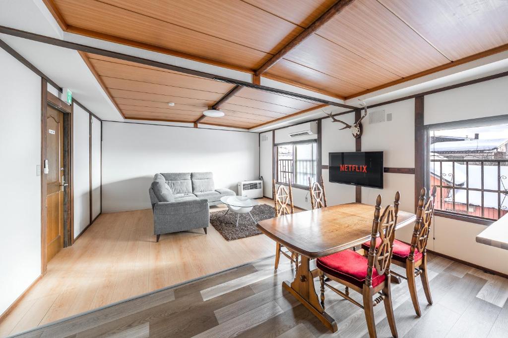 ein Wohnzimmer mit einem Tisch und einem Sofa in der Unterkunft King Deer in Higashikawa