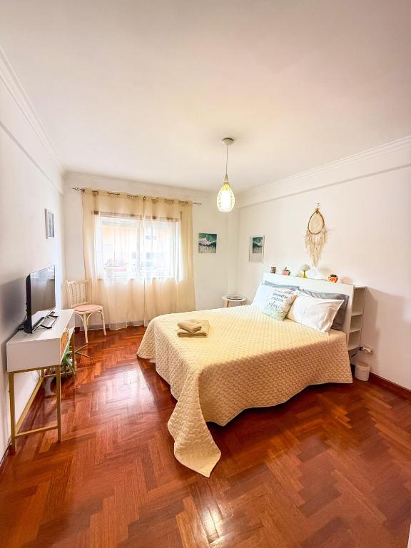 a bedroom with a bed and a desk and a television at Superhost Stay Spacious Double Rooms near Lisbon and Beaches in Corroios