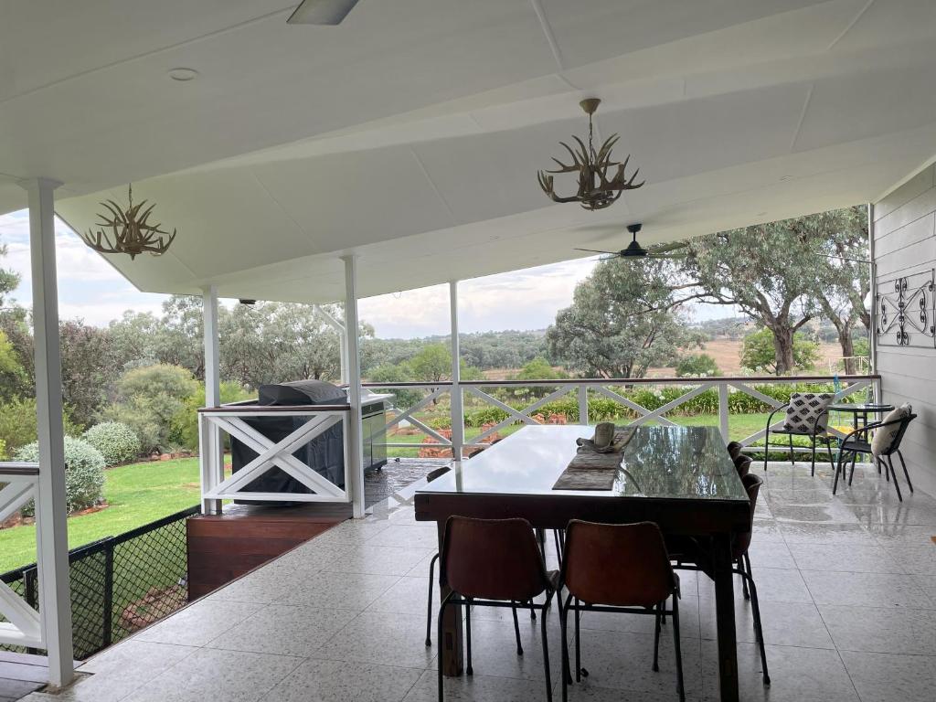 a screened in porch with a table and chairs at Drovers Run B&B and Events Venue 