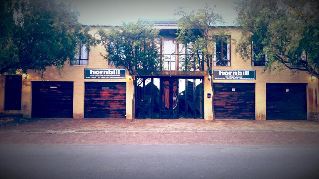 a building with two garage doors in front of it at Hornbill House Self Catering Accommodation in Hermanus