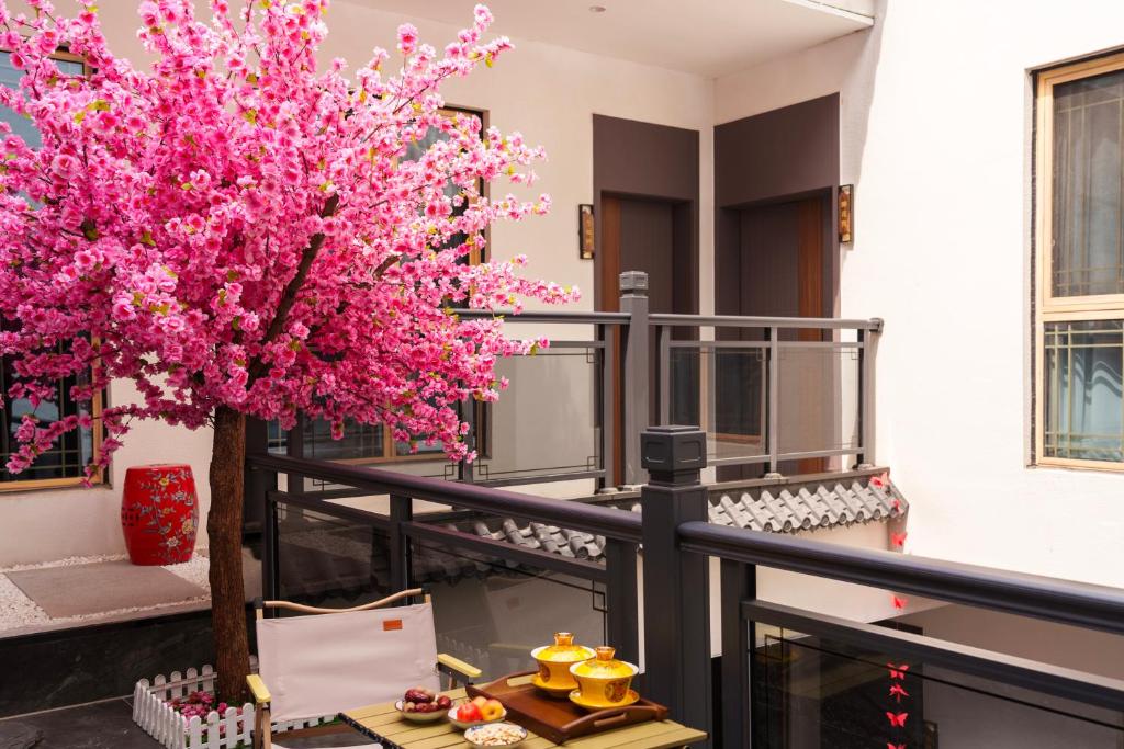 a pink tree on the balcony of a building at 西安大唐印-Siheyuan唐风设计民宿 in Xi'an