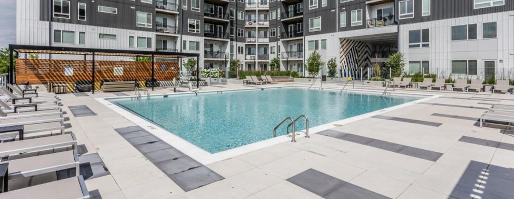 an image of a swimming pool at a apartment complex at The 513 Flat 2! 1BR, 1Bath Apt with Pool and Riverfront View! Free Gated Parking! Only Steps from The banks & Stadiums! in Cincinnati