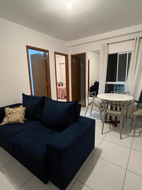 a living room with a blue couch and a table at Village do Sol 3 - Apt compartilhado in Maioba